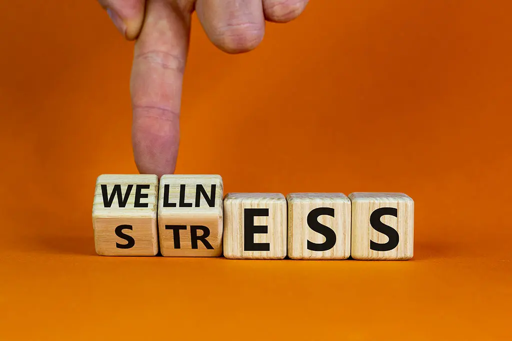 A hand pointing at a wellness or stress block
