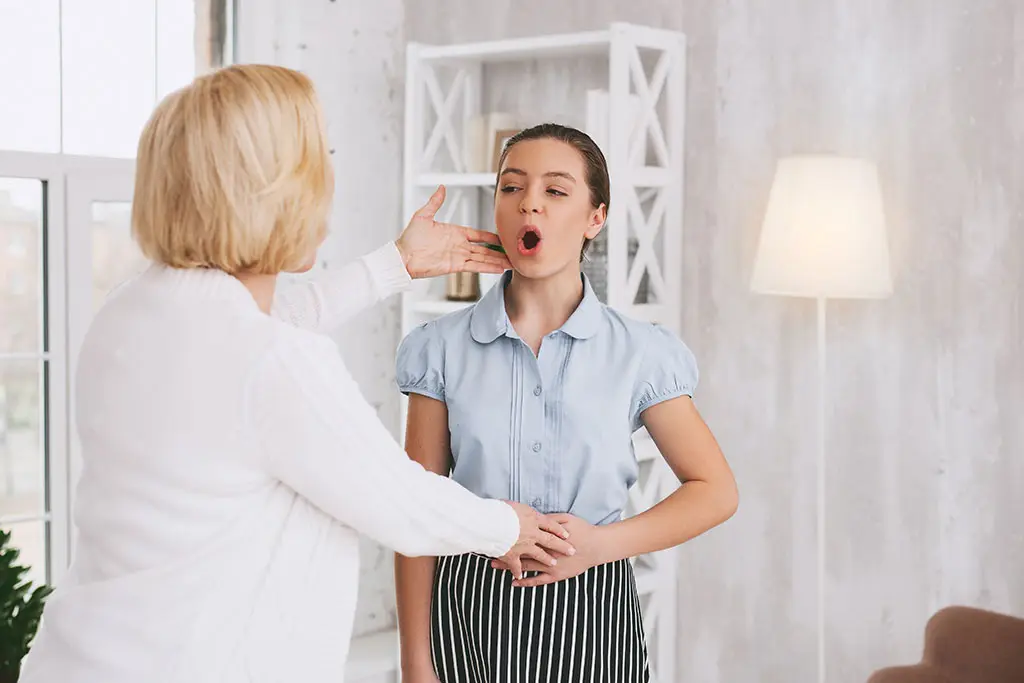A teacher and young student doing vocal exercises