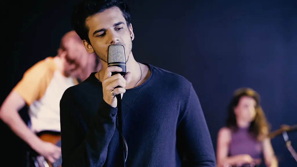 A young man singing in a band