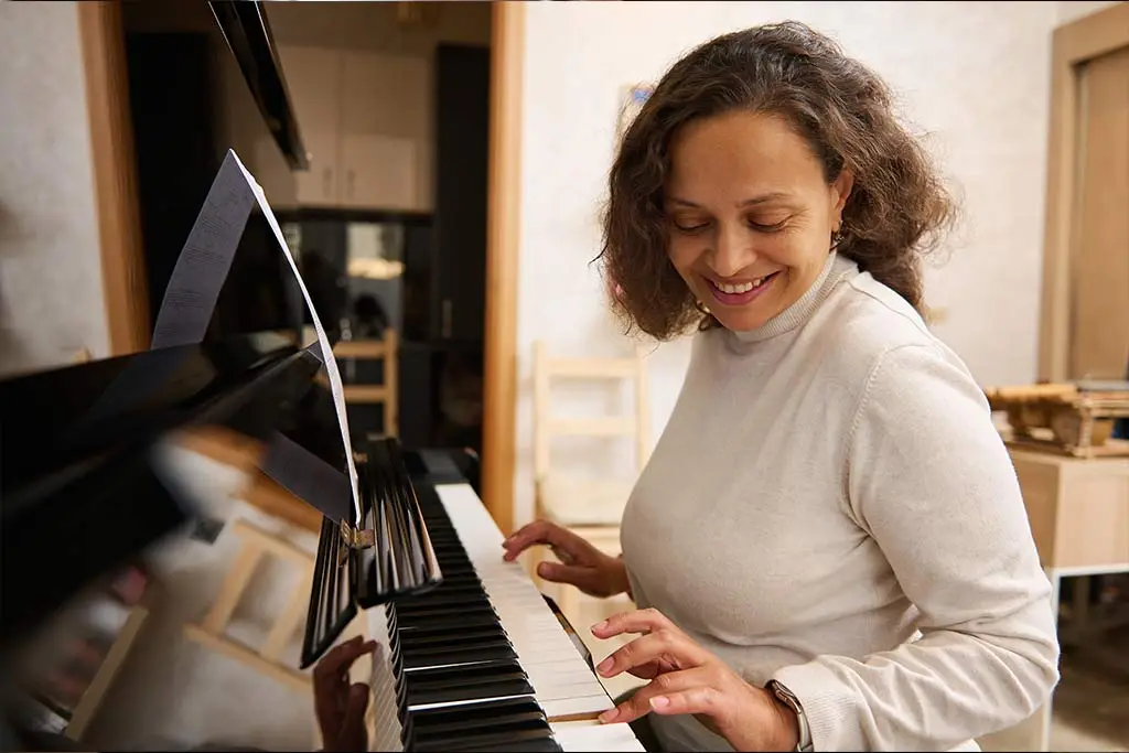 Adult woman smiling playing piano