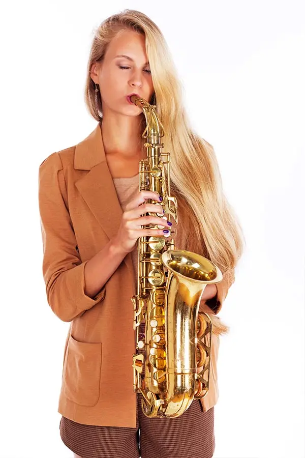 Beautiful blonde woman playing saxophone