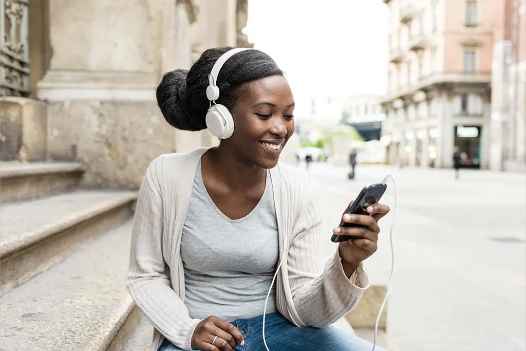 Beautiful woman listening to music outdoor