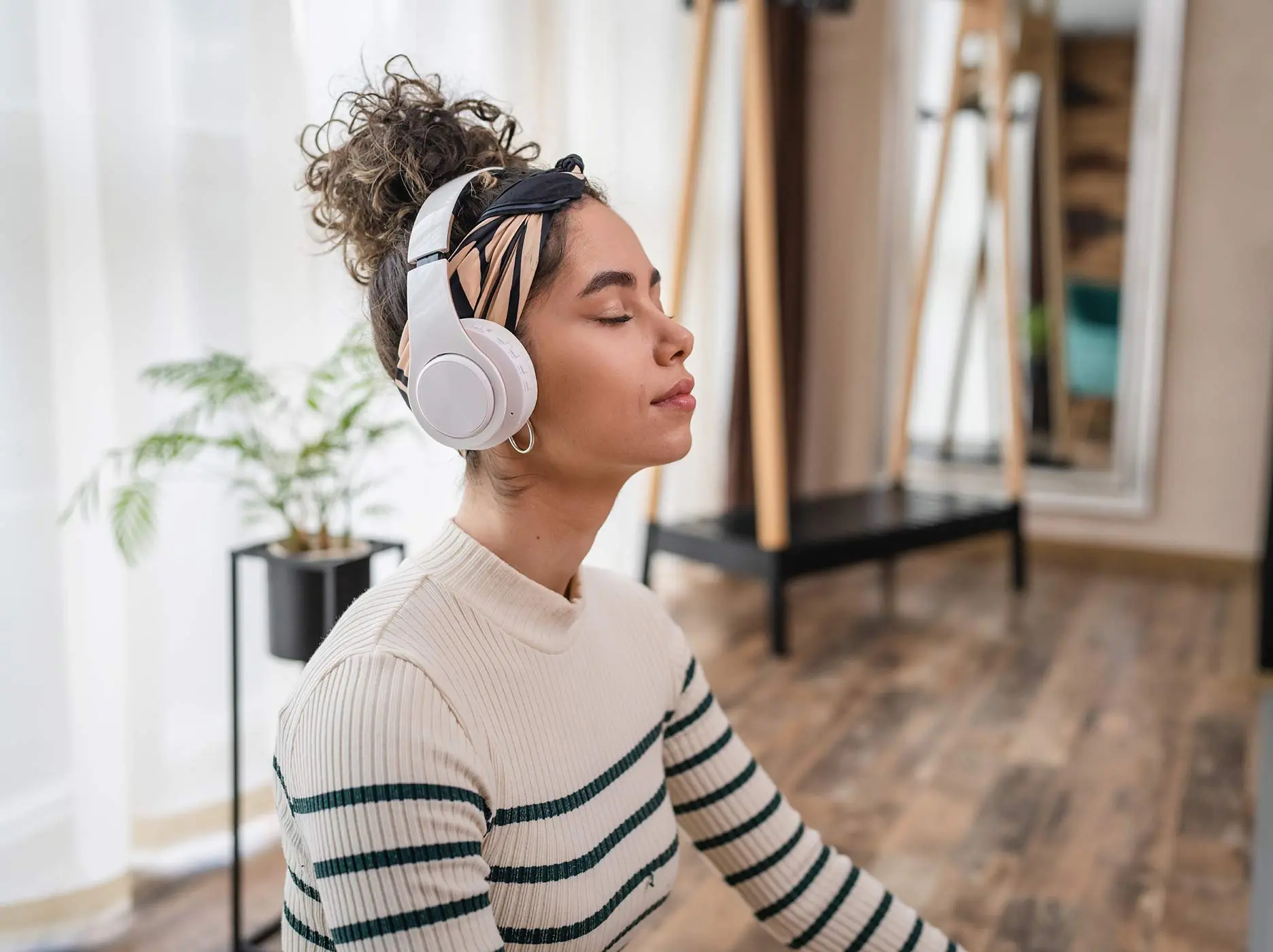 Beautiful woman listening to music with eyes closed