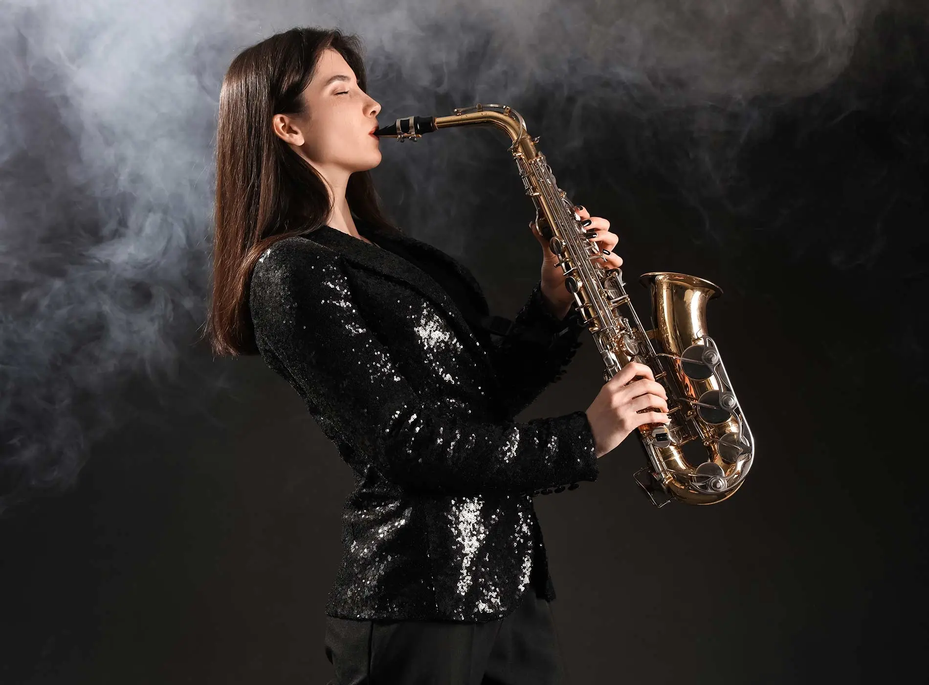 Beautiful woman playing saxophone