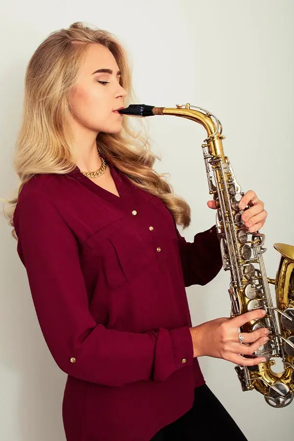 Beautiful woman playing saxophone