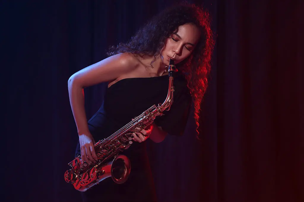 Beautiful woman playing saxophone