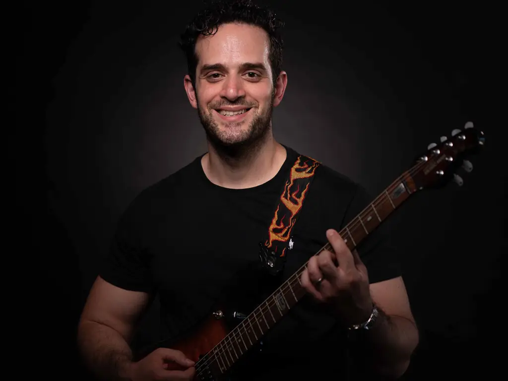 Christopher profile pic with guitar