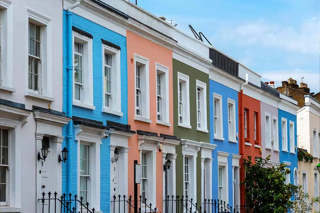 Colourful terraced houses with white-framed windows and railings