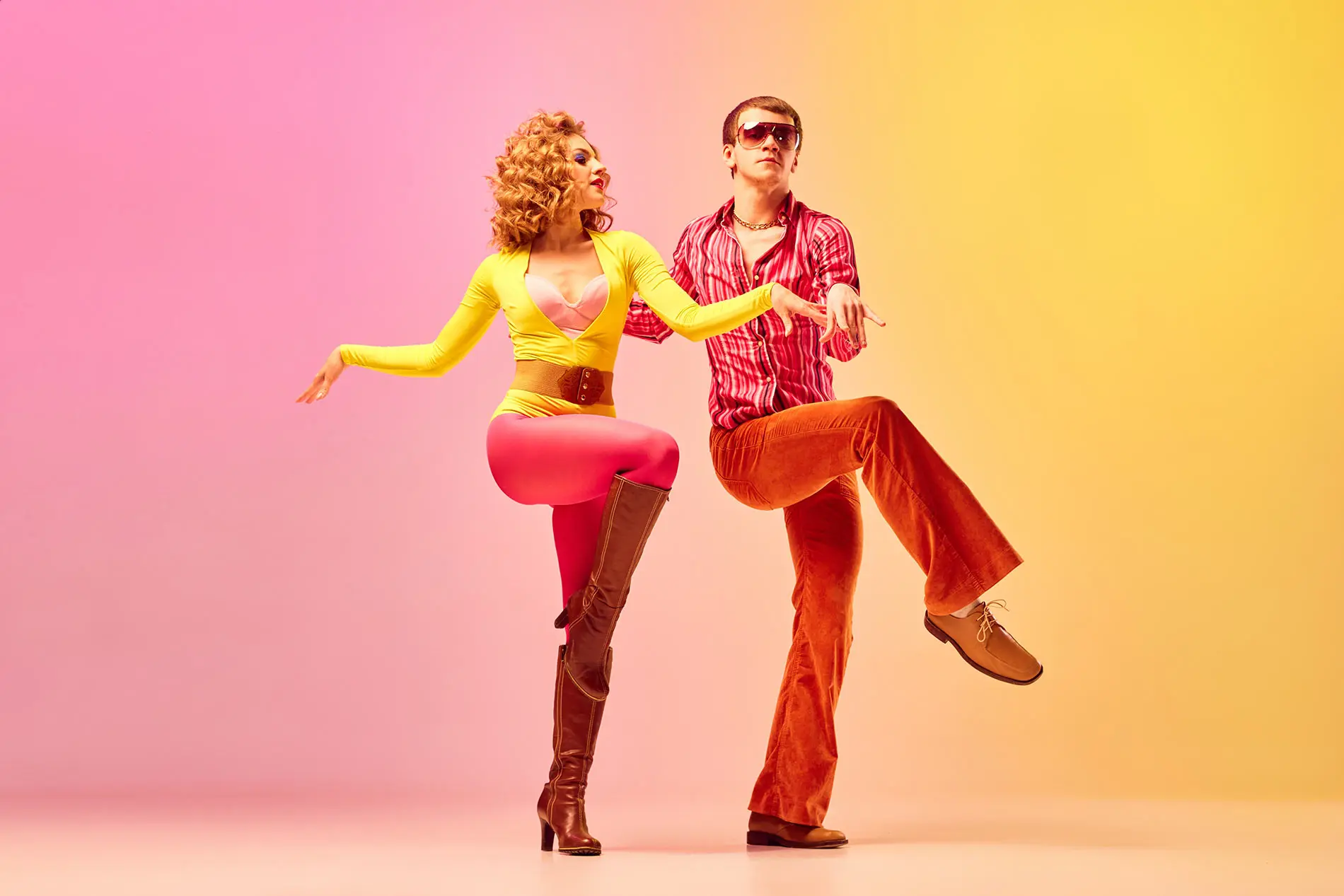 Man and woman dancing disco style with vibrant background