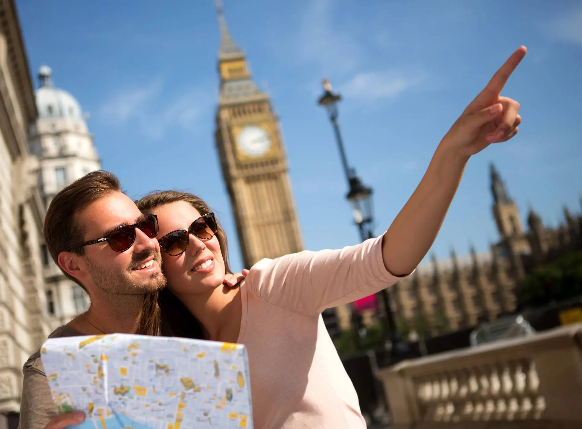Couple holding a map near Big Ben in London