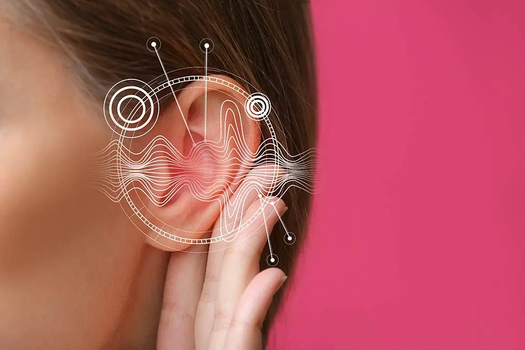 Close-up of a woman touching her ear with sound wave graphics