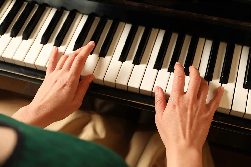 Female hands on piano keyboard