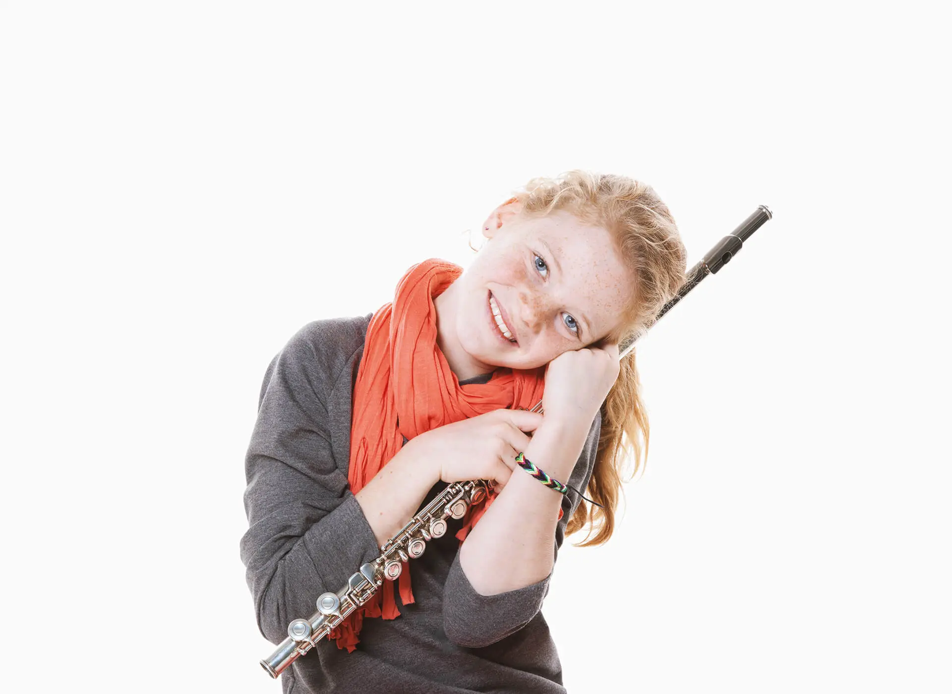 Smiling girl holding a flute against a white background