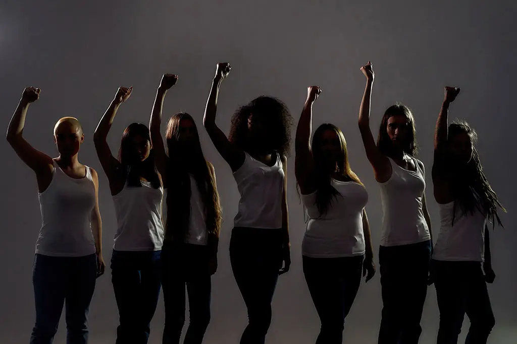 Image of group of diverse women raised their arms