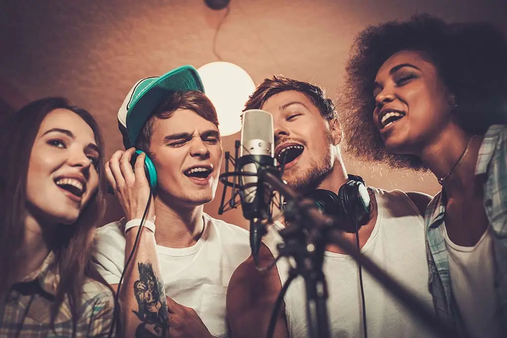 group of young modern singers recording a song