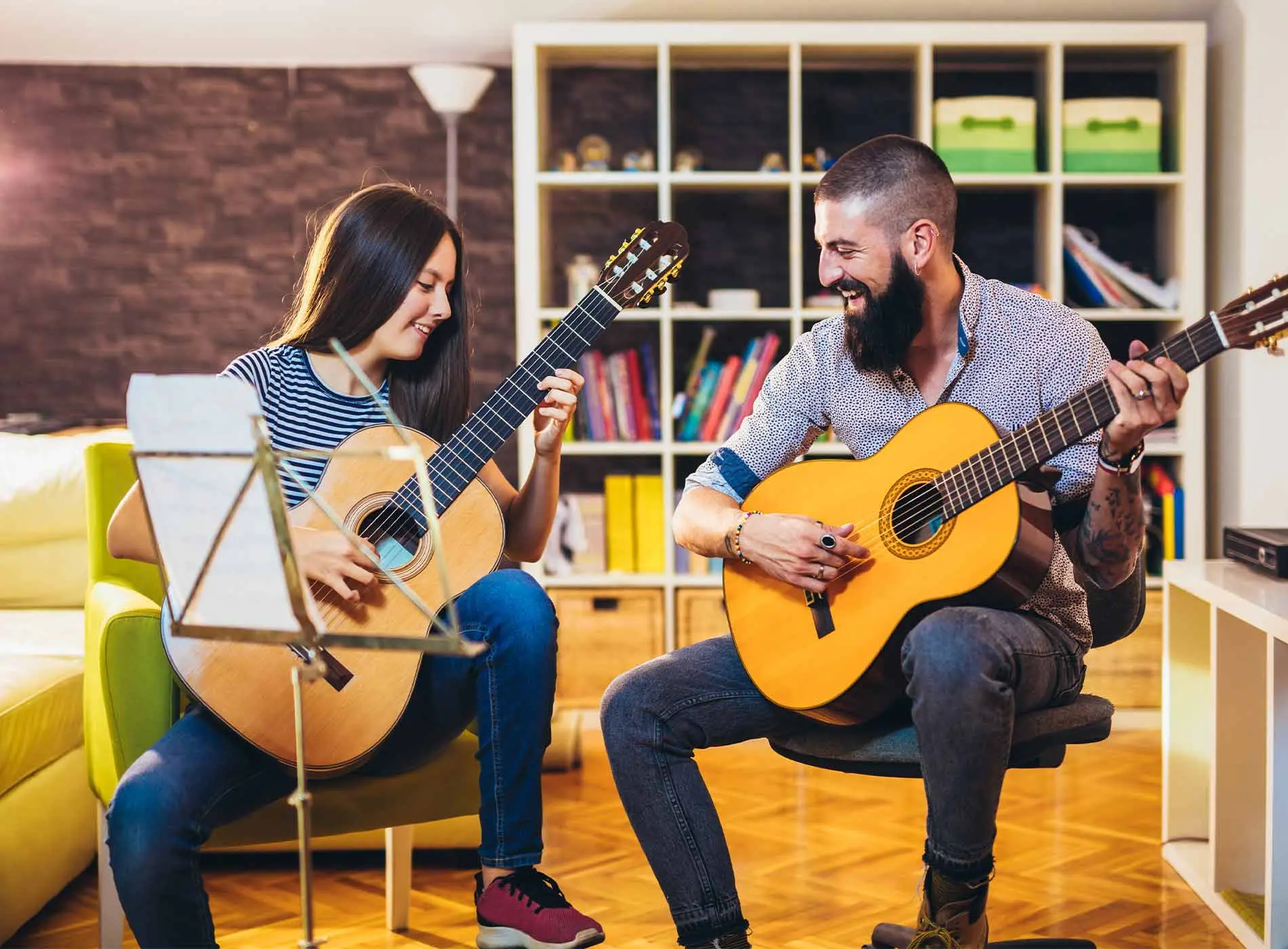 Guitar teacher and student having fun during lessons