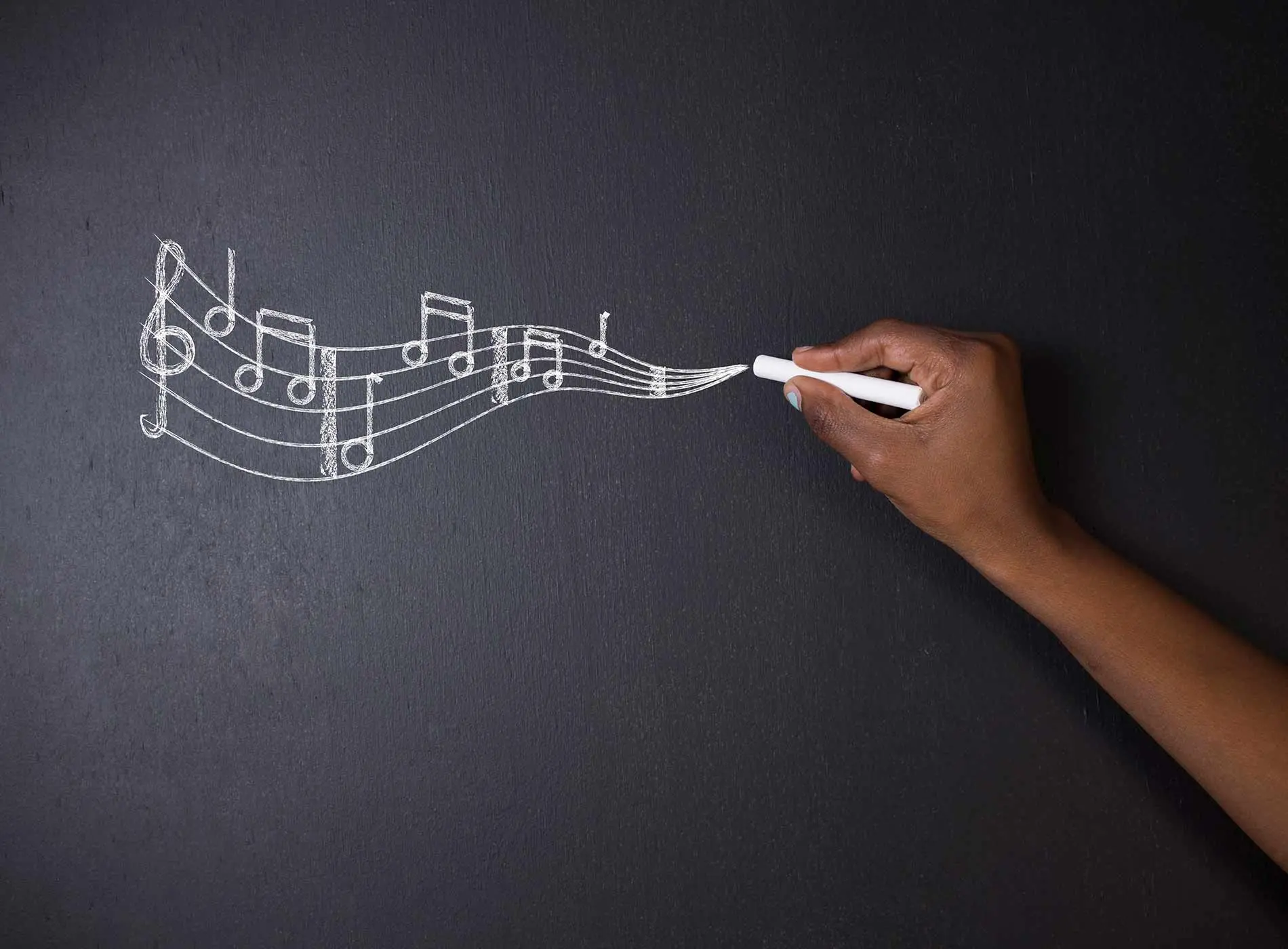 Music teacher drawing on a board