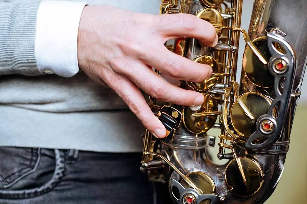 Close-up of a hand pressing saxophone keys