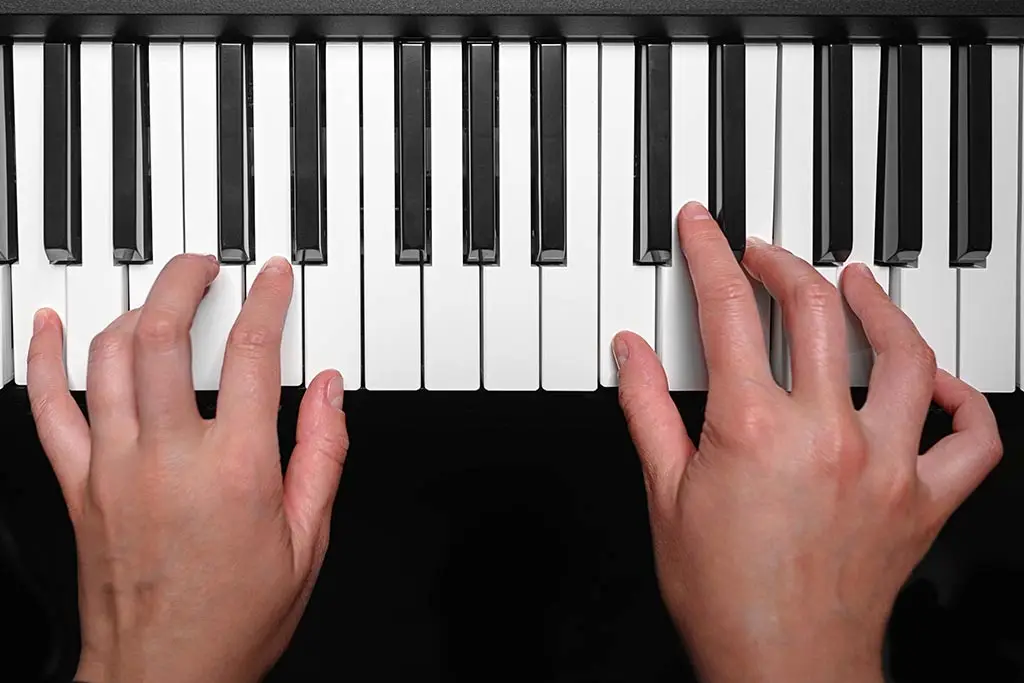 Hands on piano keyboard