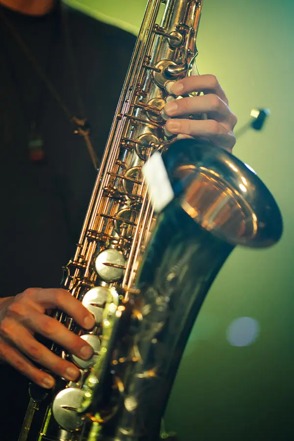 Hands on the keys of a saxophone