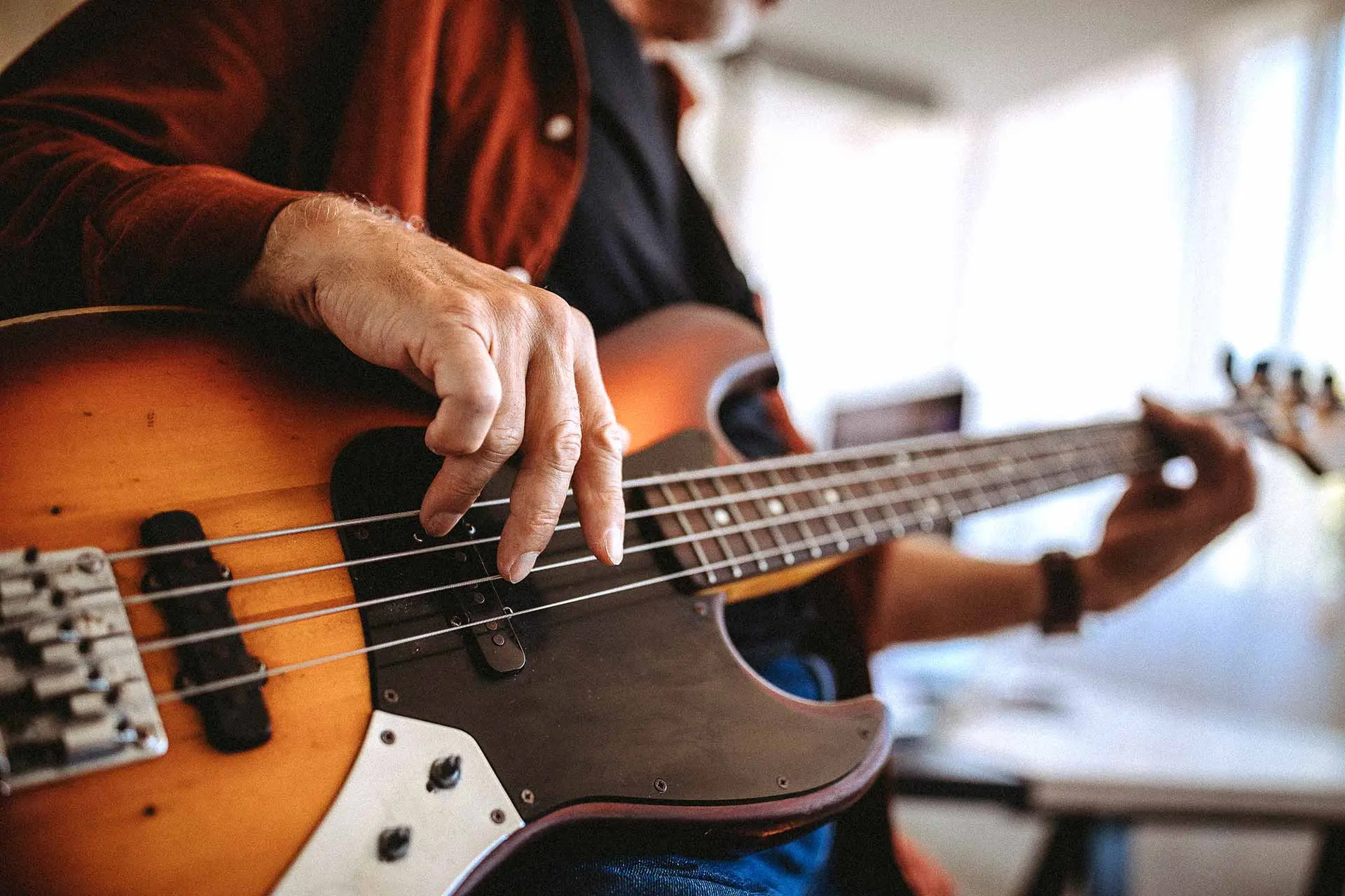 Close-up of a bass player’s hands on the strings
