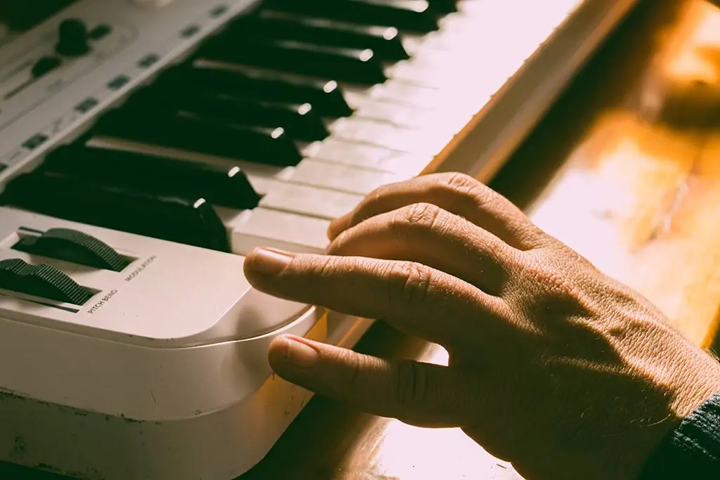 Hands playing digital keyboard piano