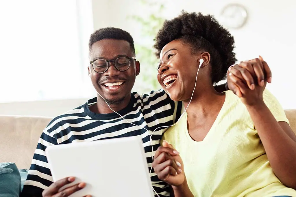 Happy couple listening to music together