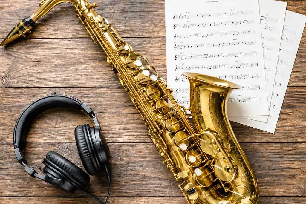 Headphones, saxophone and sheet music