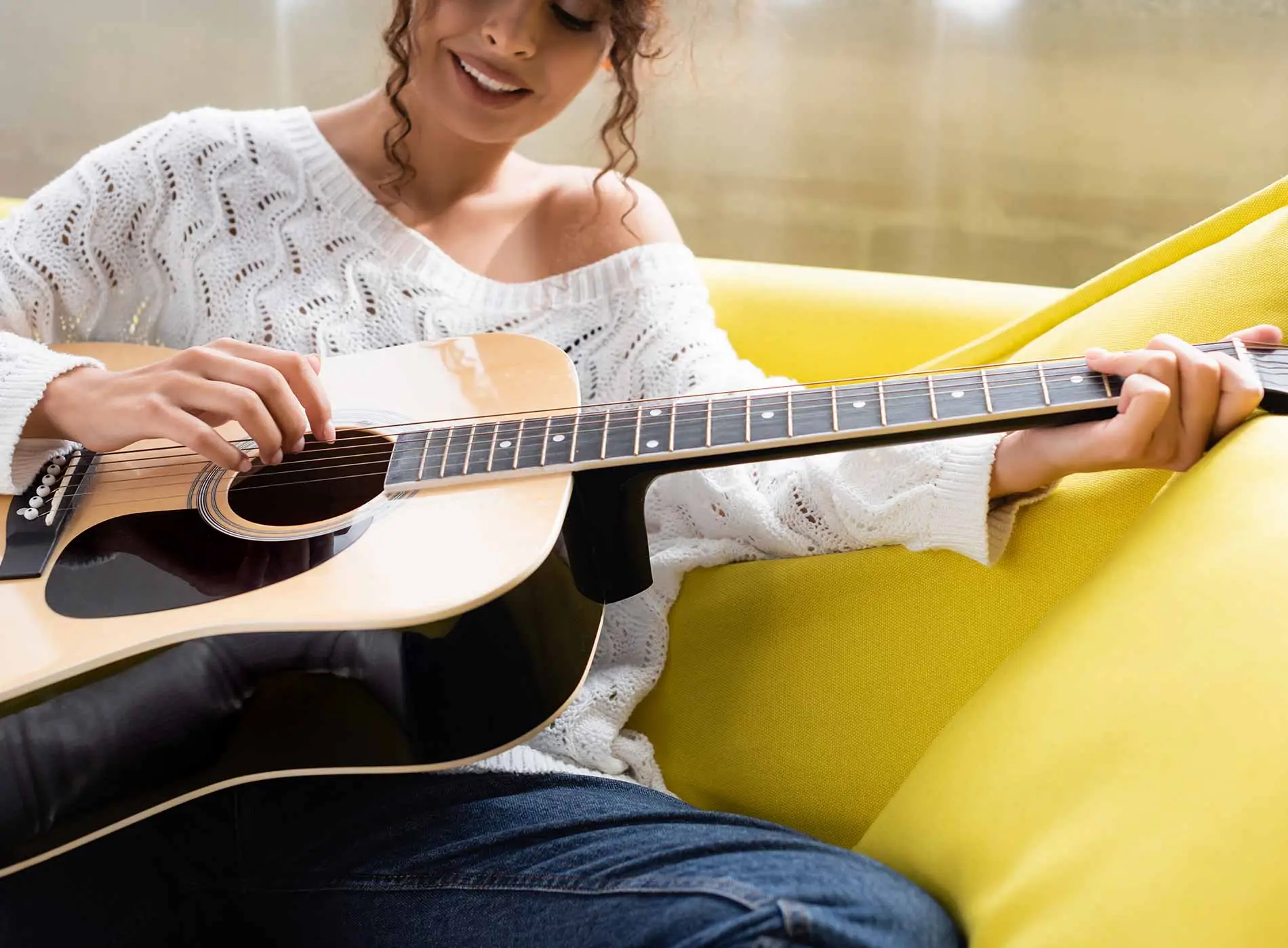 Lady learning to play the guitar