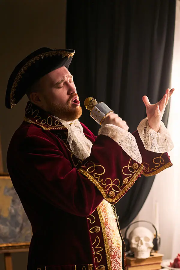 Male singer in period costume performing with a microphone