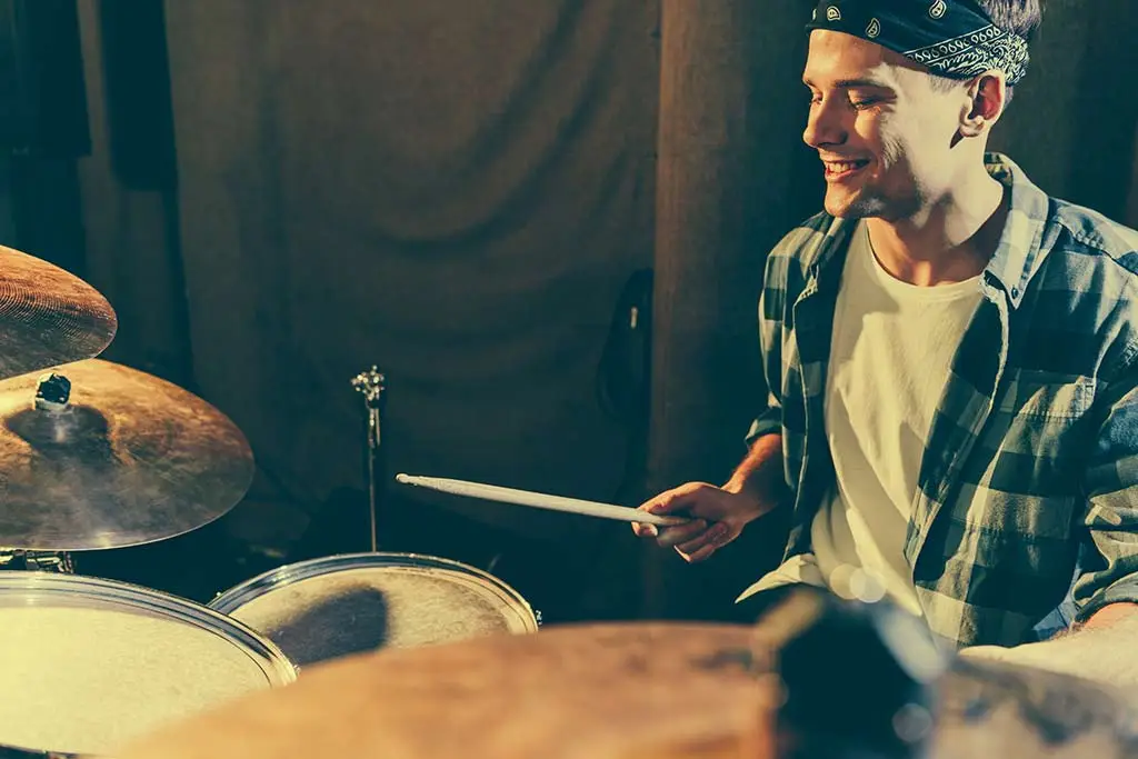 Man cheerfully playing the drums