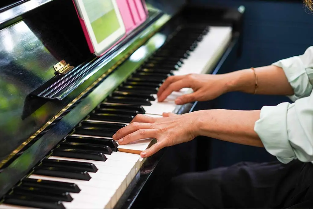 Man hands playing piano