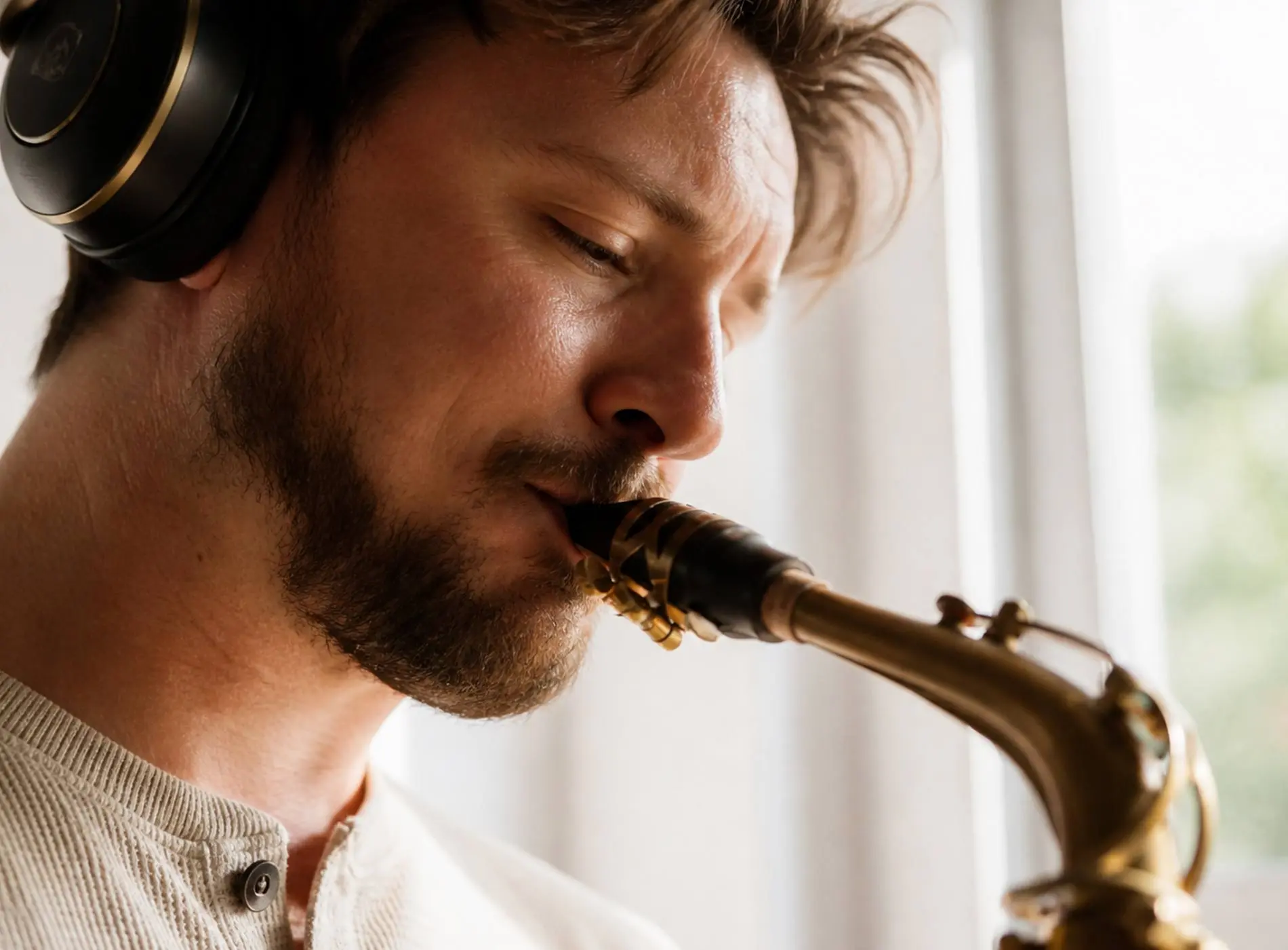 Man saxophonist with headphone playing