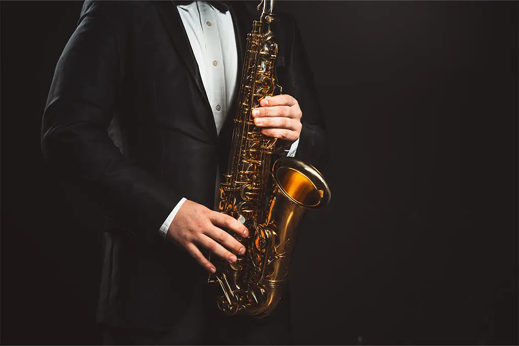 Man in suit holding saxophone