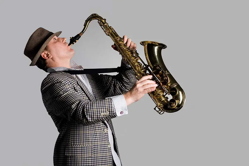 Man in suit playing saxophone