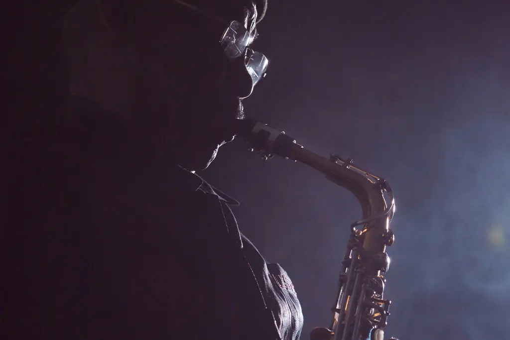 Man in the dark playing saxophone