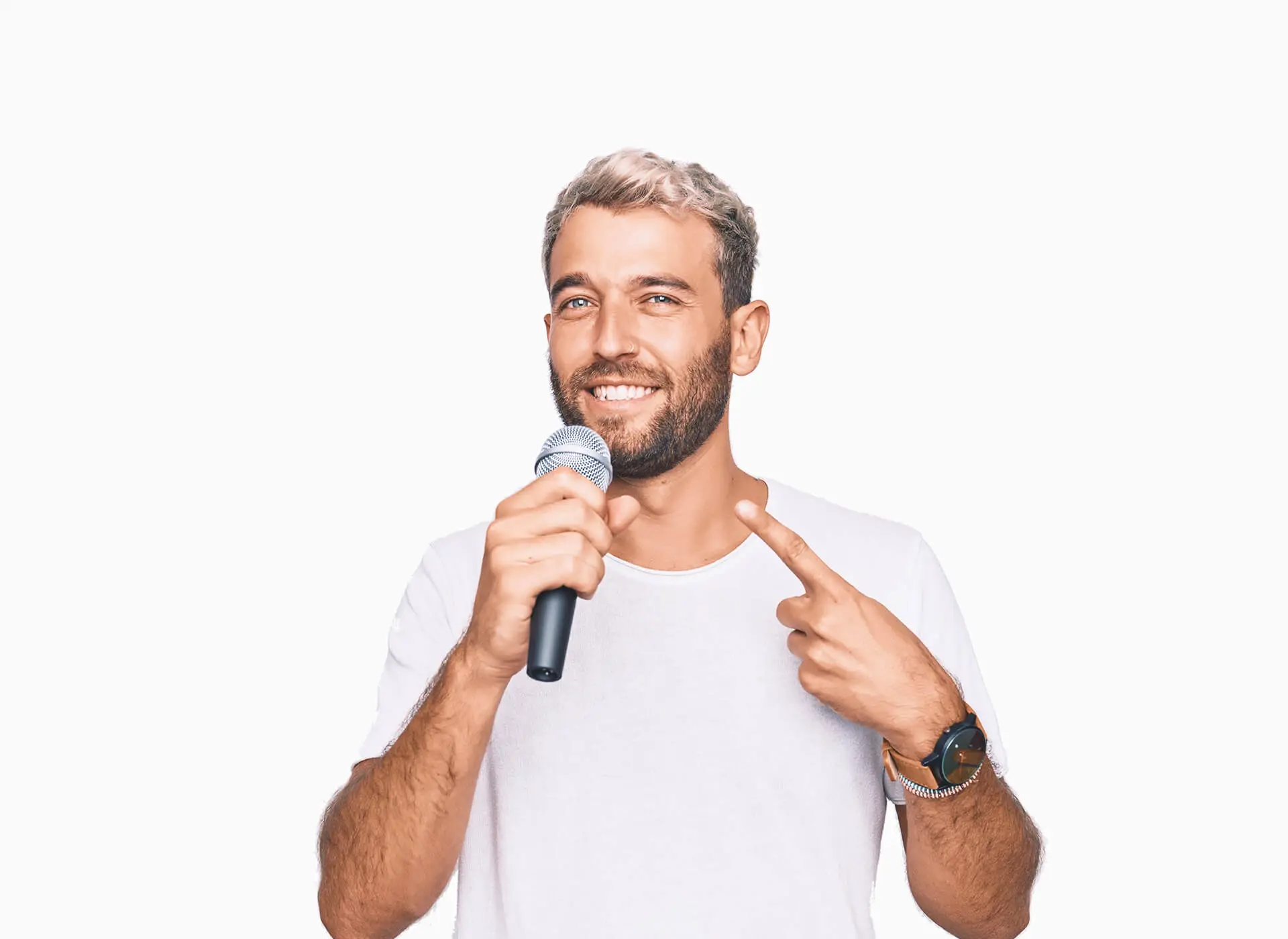 Man in a white T-shirt holding a microphone and smiling