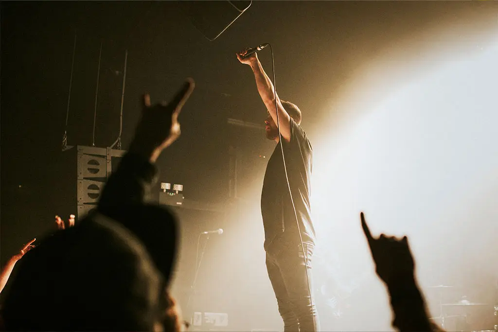 Man on stage holding microphone up