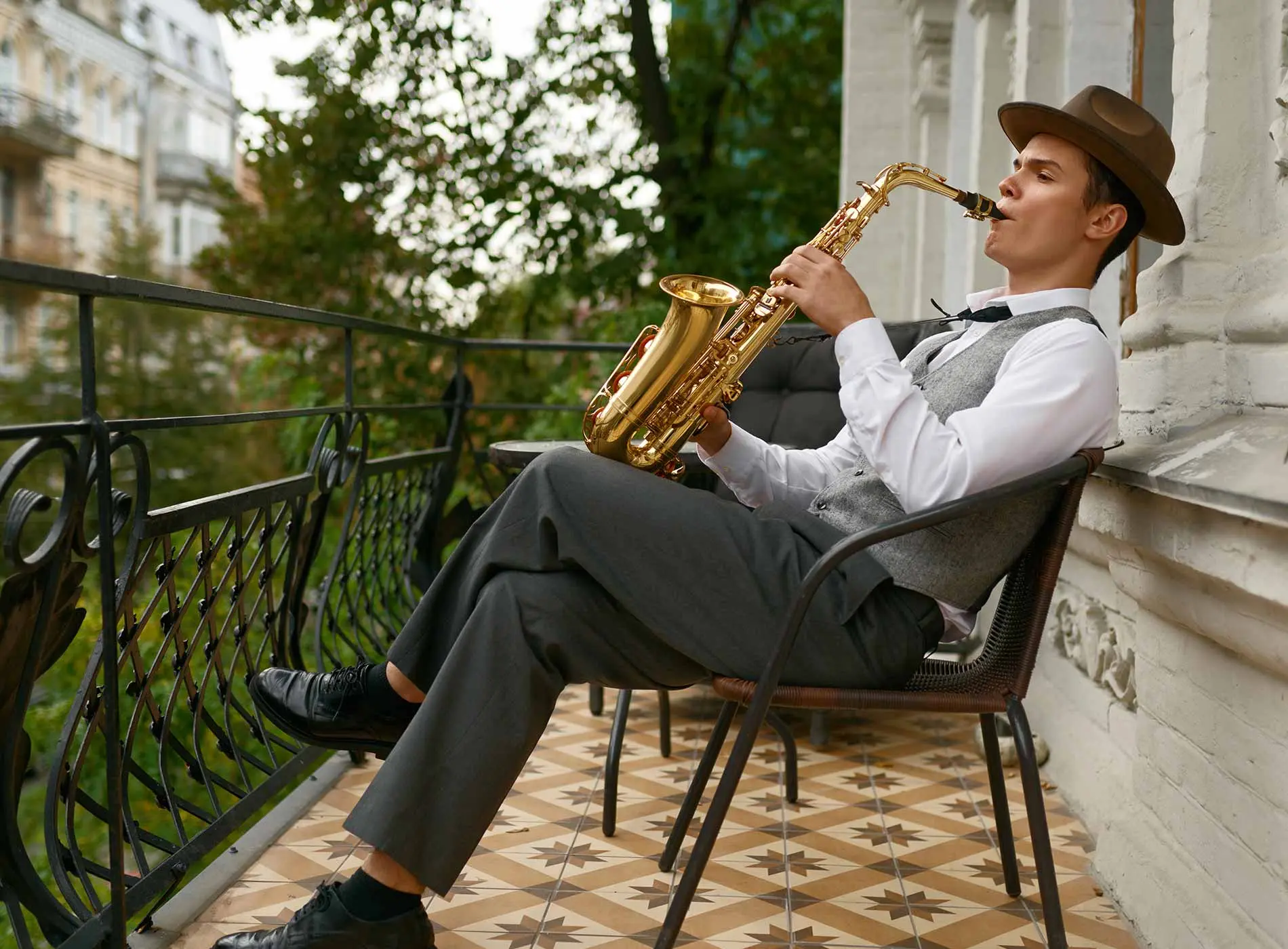 Male saxophonist playing on a balcony