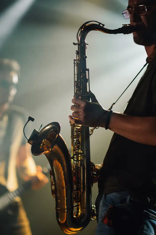 Man playing a baritone saxophone on stage