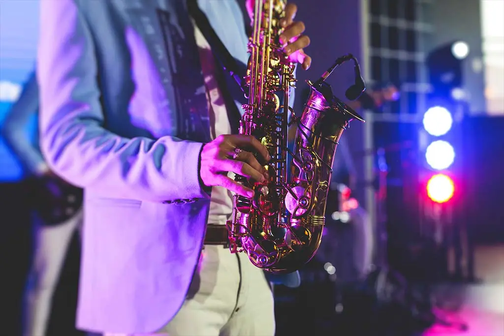 Man playing holding a saxophone