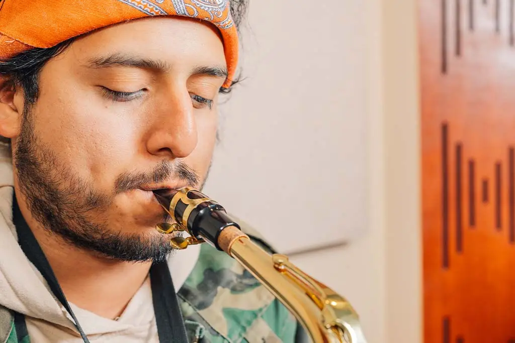Man playing saxophone in a close-up view
