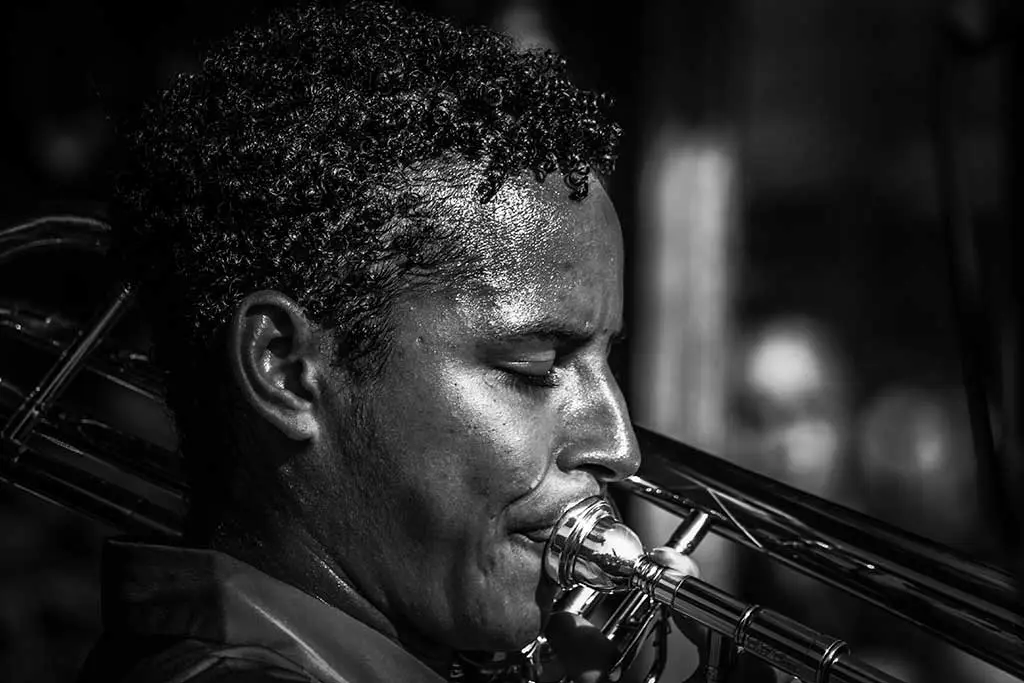 Man playing trombone in black and white