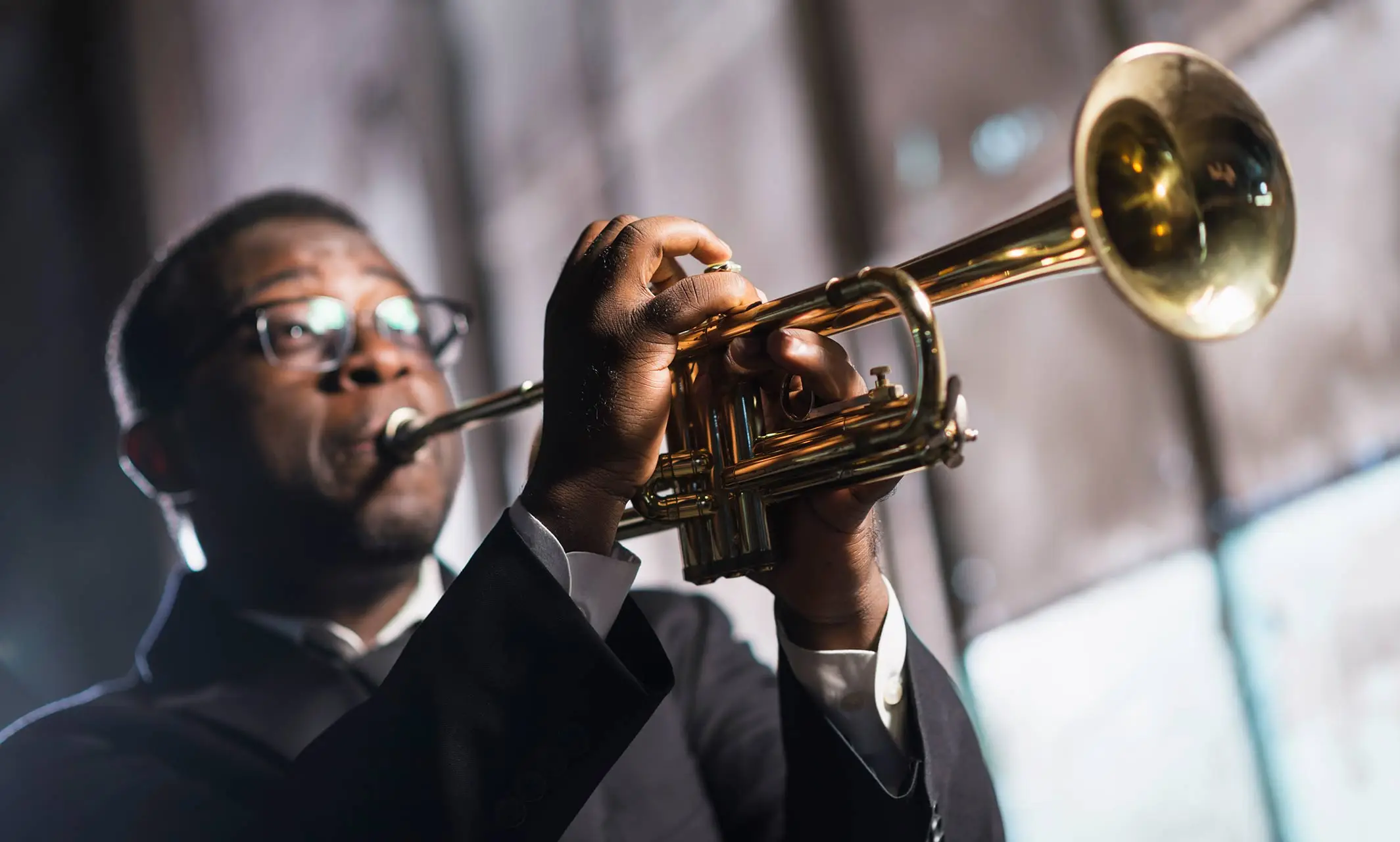 Man in a suit playing a trumpet