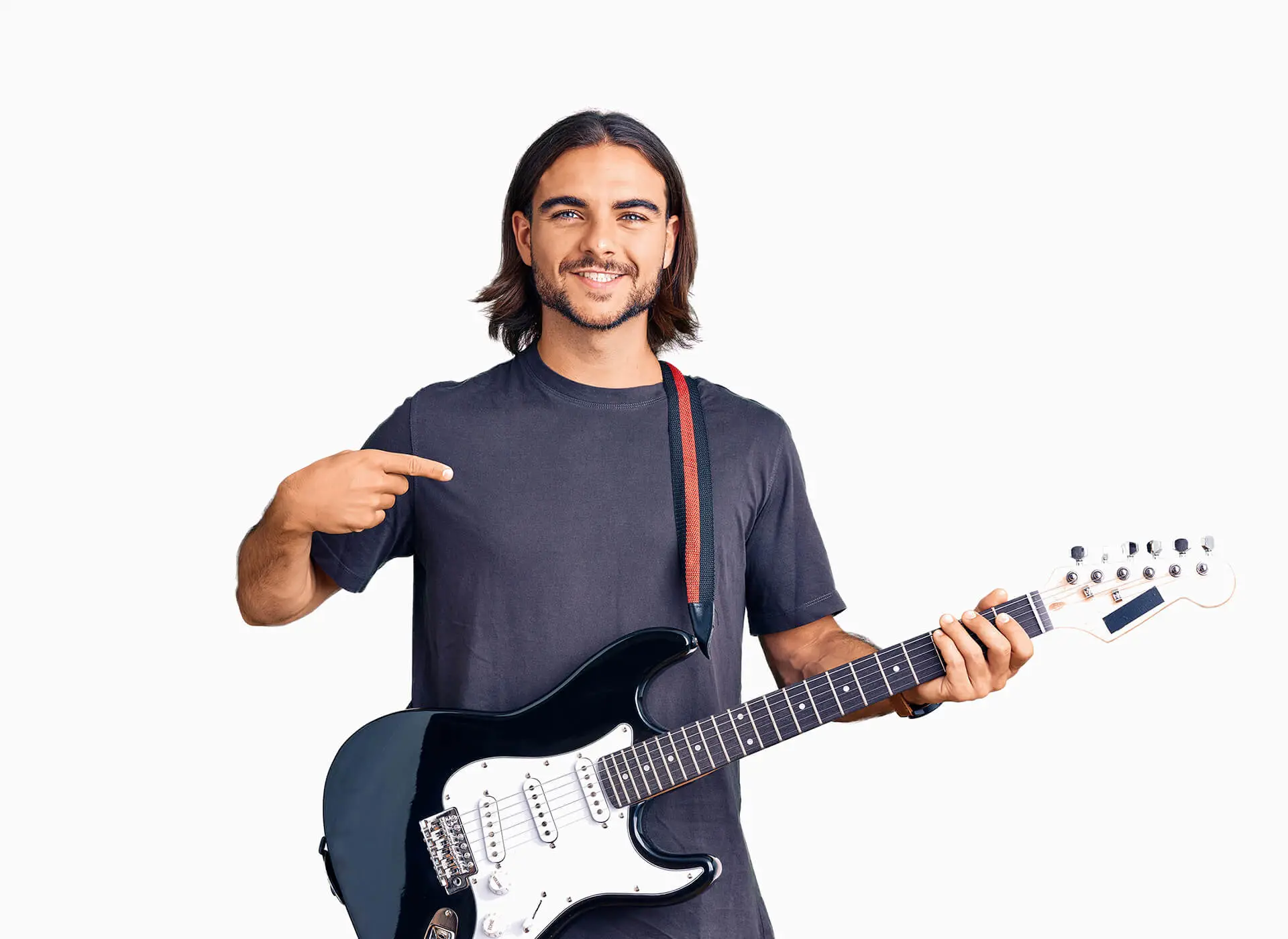 Smiling man pointing at himself while holding an electric guitar