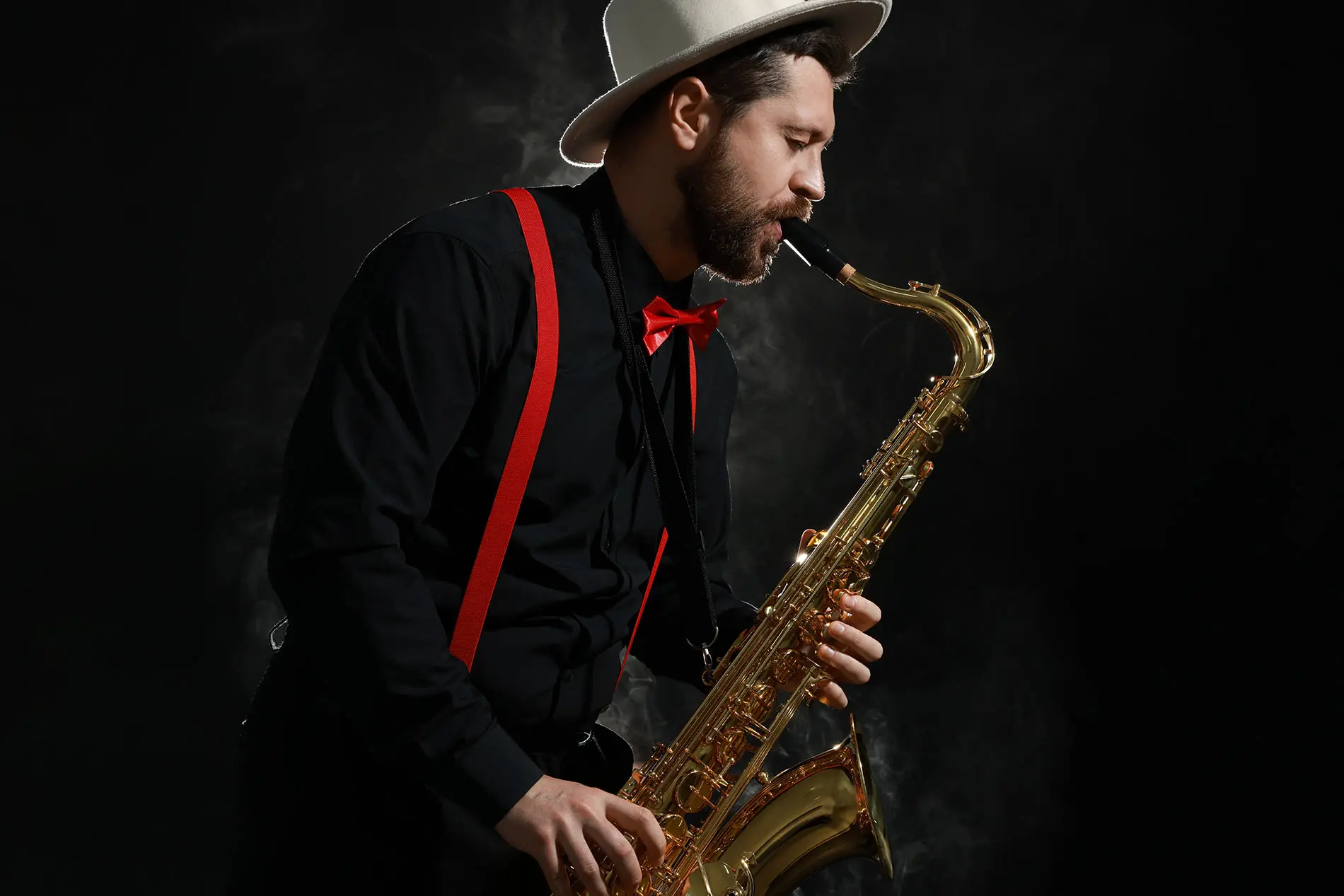 Man with hat playing saxophone
