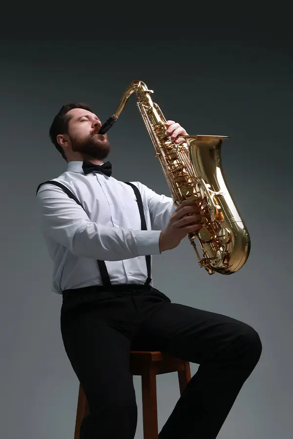 Man singing playing saxophone