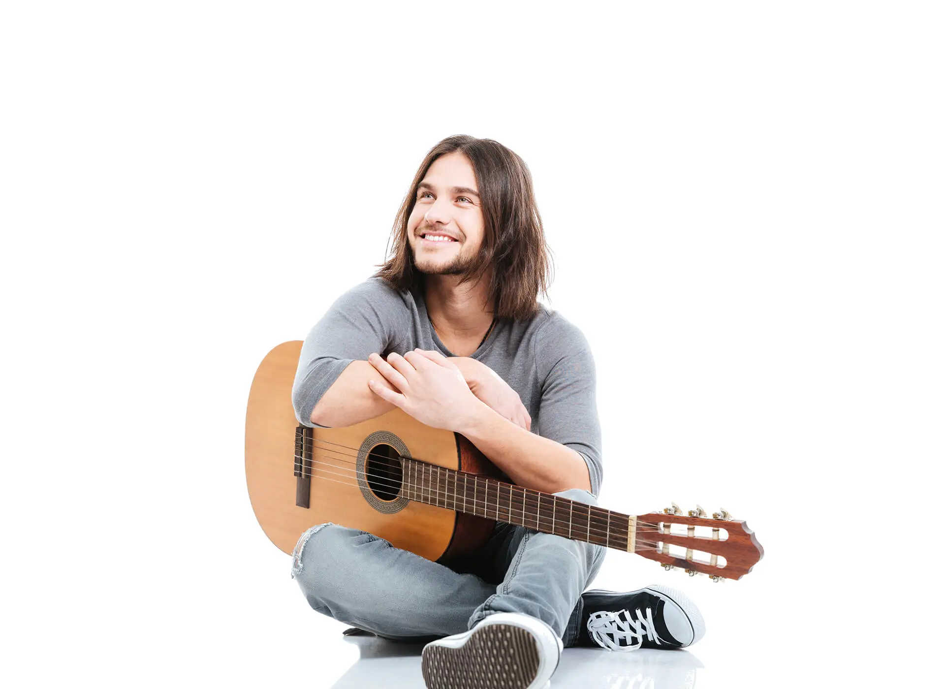 Man sitting smiling guitar