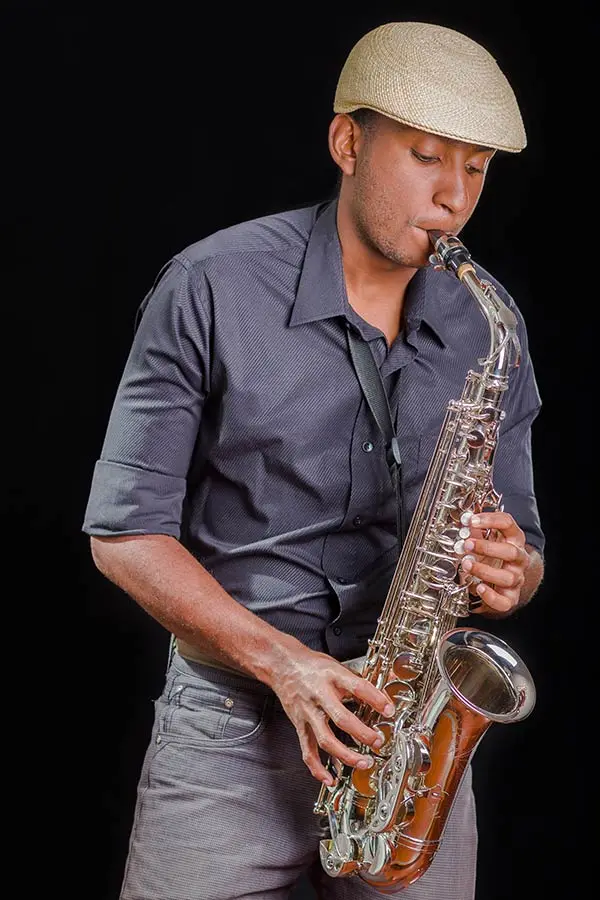 Man wearing a hat playing saxophone