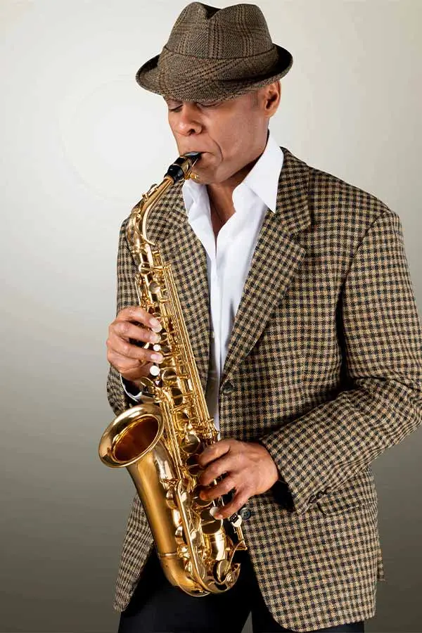 Man wearing a suit playing a saxophone